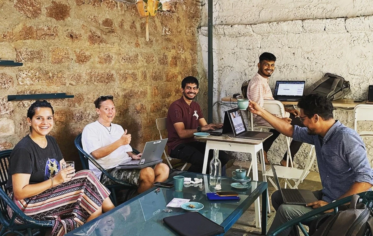 The GrandWorks team working together over laptops and coffee